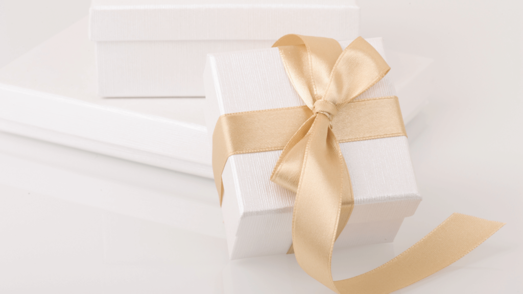 Corporate holiday party gift box with gold ribbon
