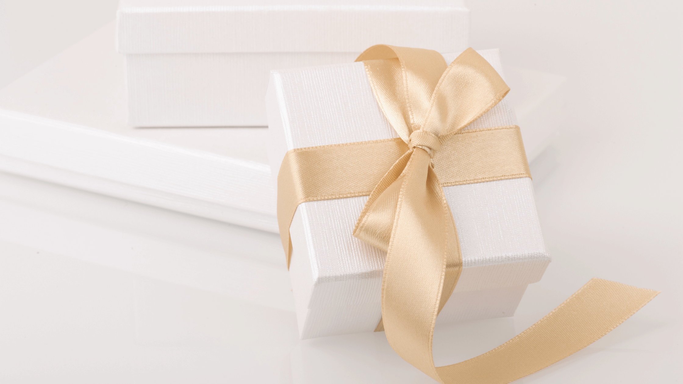 Corporate holiday party gift box with gold ribbon