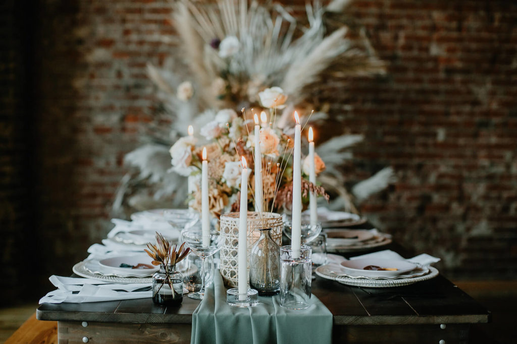 Fall wedding tablescape with candles and dried florals